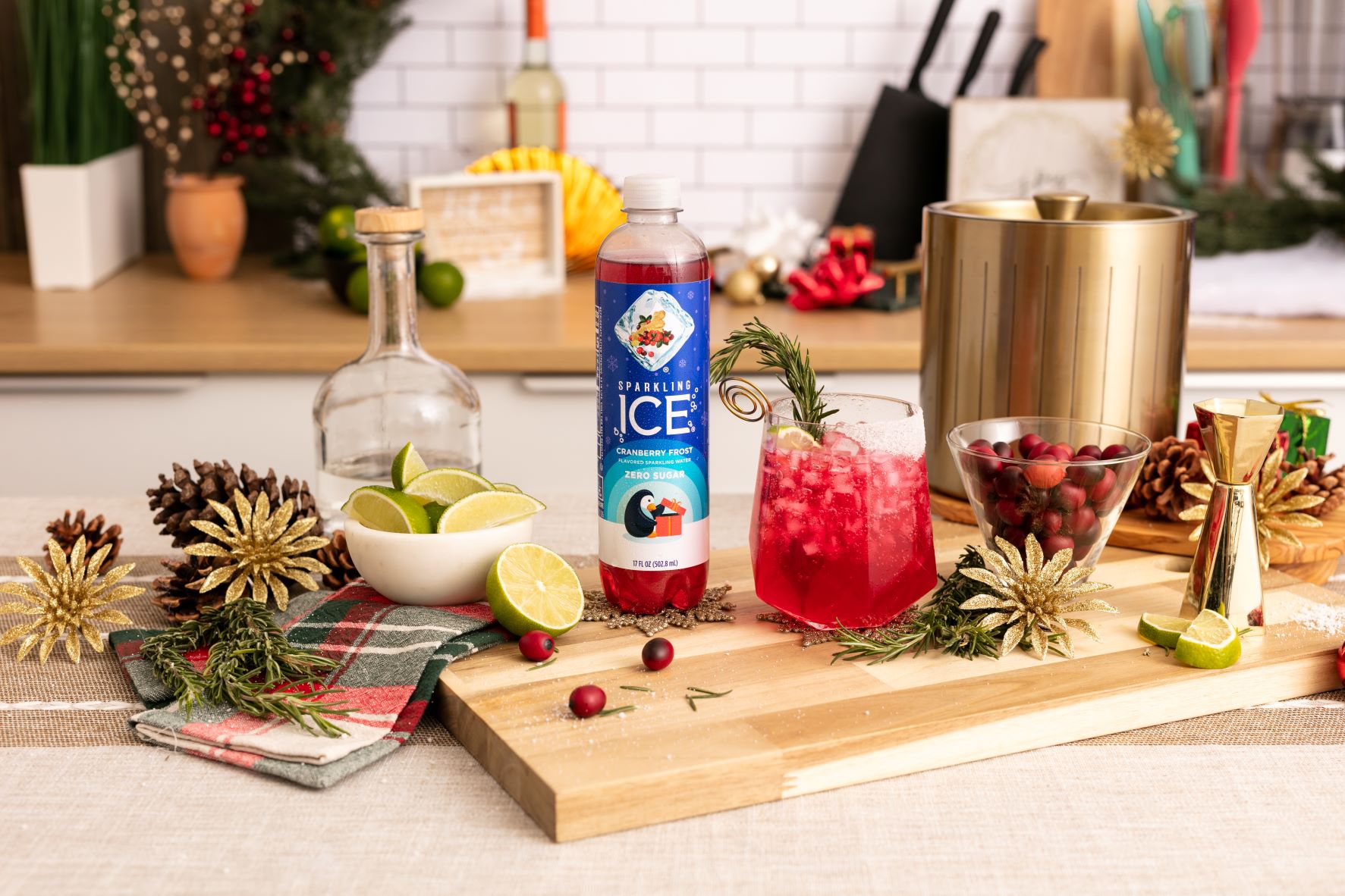 sparkling ice cranberry frost on cutting board with winter ruby cocktail limes and cranberries in glass