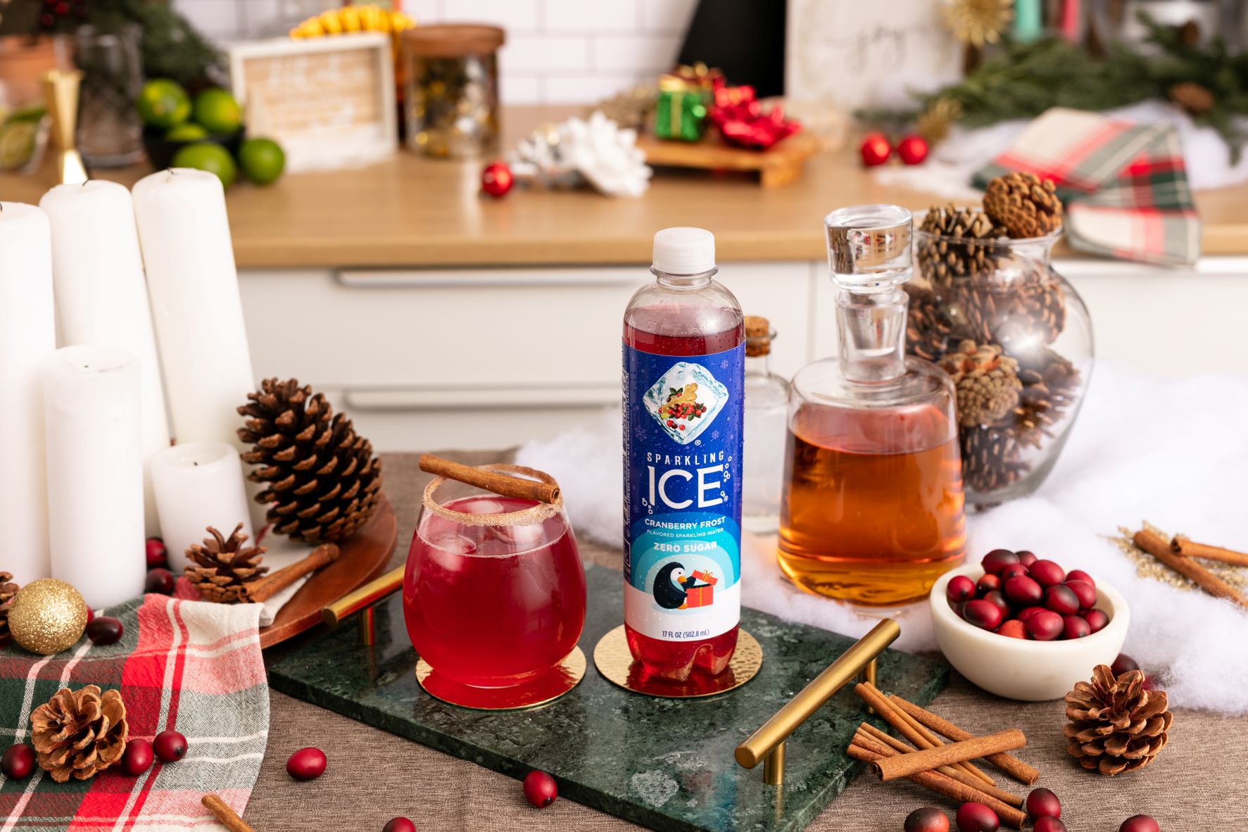 sparkling ice cranberry frost on table with cinnamon and glass jar filled whiskey
