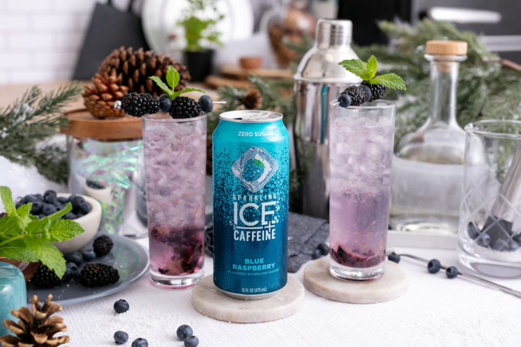 sparkling ice plus caffeine blue raspberry next to blueberry vodka spritz garnished with blackberries