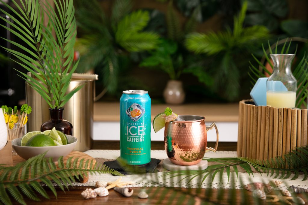 Sparkling Ice Tropical Mock-mule ginger and lime drink in copper mug next to can of Sparkling Ice Tropical Punch.